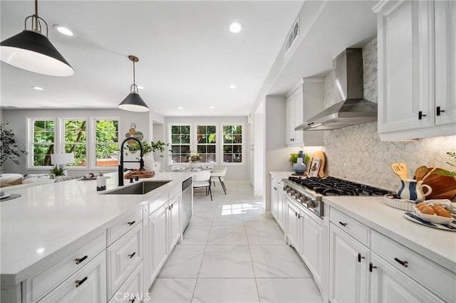 19 Ivanhoe, Irvine, CA 92602 - kitchen featuring marble finish floor, light countertops, visible vents, a sink, and wall chimney exhaust hood