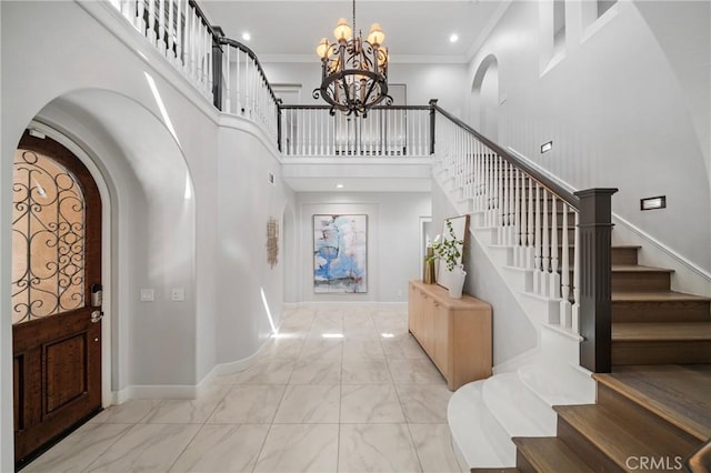 19 Ivanhoe, Irvine, CA 92602 - entryway with marble finish floor, arched walkways, an inviting chandelier, a towering ceiling, and baseboards