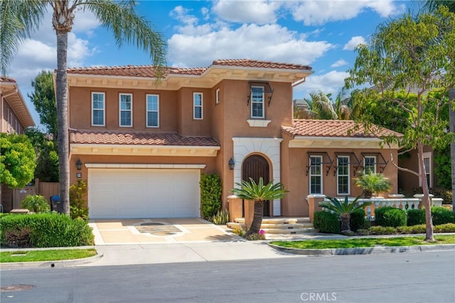 19 Ivanhoe, Irvine, CA 92602 - mediterranean / spanish house featuring an attached garage, a tile roof, stucco siding, and concrete driveway