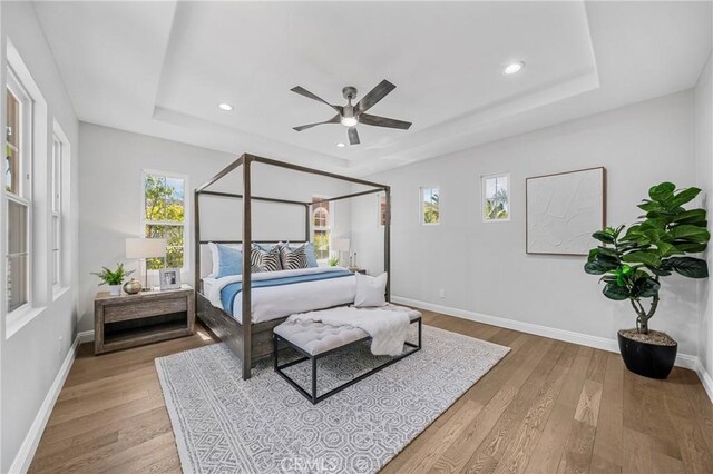 19 Ivanhoe, Irvine, CA 92602 - bedroom with wood finished floors, a tray ceiling, and recessed lighting