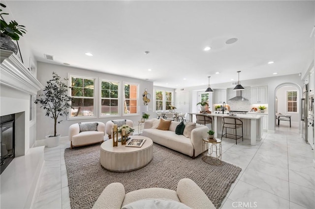 19 Ivanhoe, Irvine, CA 92602 - living room featuring visible vents, a glass covered fireplace, recessed lighting, and marble finish floor