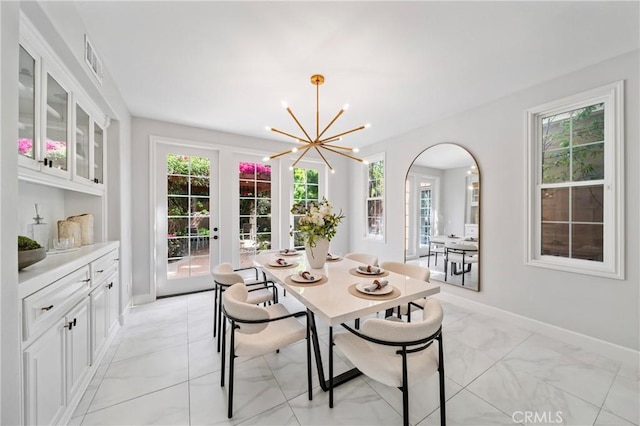 19 Ivanhoe, Irvine, CA 92602 - dining space with baseboards, a wealth of natural light, and an inviting chandelier