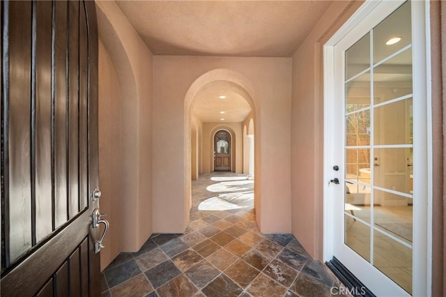 19 Ivanhoe, Irvine, CA 92602 - interior space with arched walkways, stone finish flooring, french doors, and recessed lighting