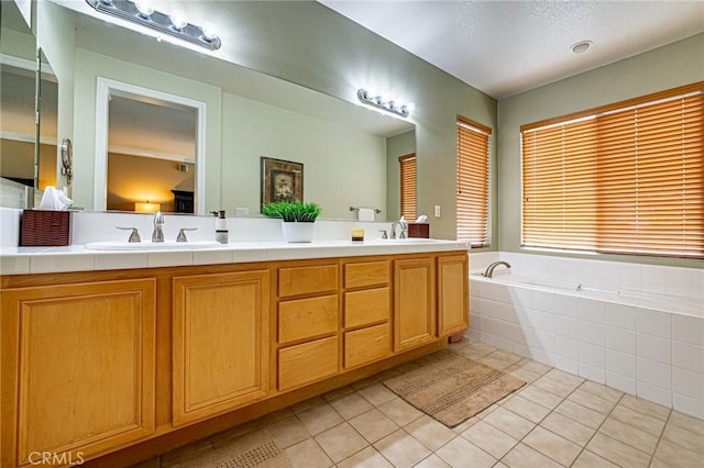 bathroom with double vanity, a sink, tile patterned flooring, and a garden tub