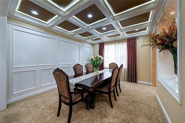 dining room featuring recessed lighting, coffered ceiling, light carpet, and a decorative wall