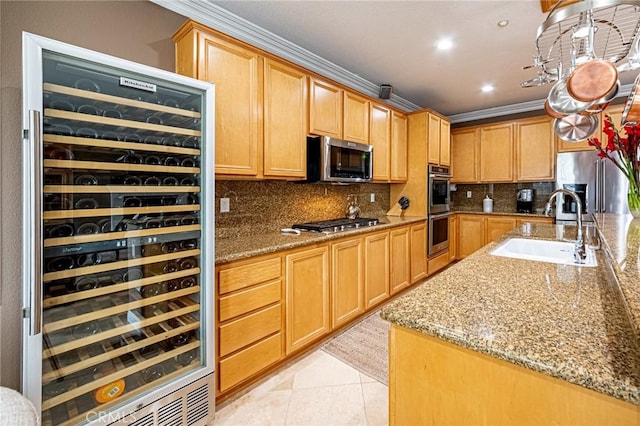kitchen with crown molding, beverage cooler, tasteful backsplash, a sink, and stainless steel appliances