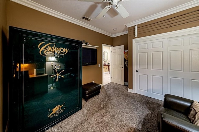 interior space with ceiling fan, visible vents, baseboards, ornamental molding, and carpet flooring