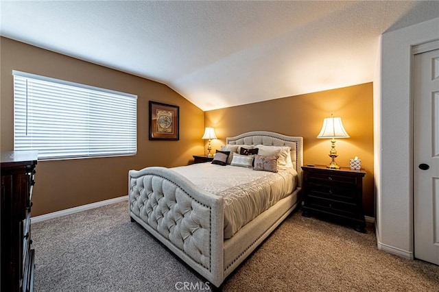 carpeted bedroom with baseboards and vaulted ceiling