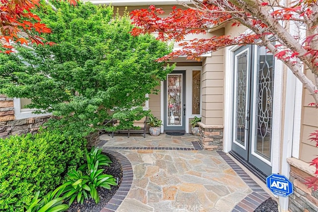 property entrance with stone siding