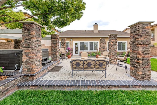 view of patio / terrace featuring an outdoor living space with a fireplace