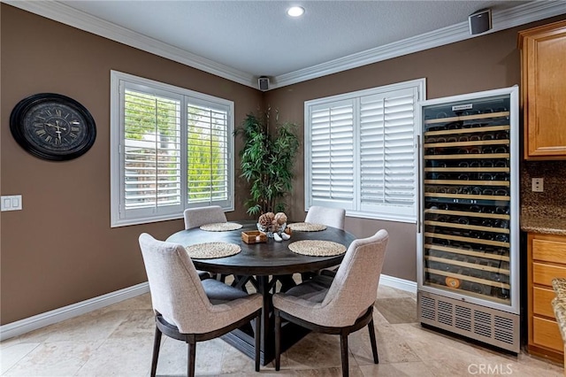 dining area featuring baseboards, ornamental molding, wine cooler, and light tile patterned floors