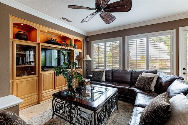 living area with visible vents, a ceiling fan, and crown molding