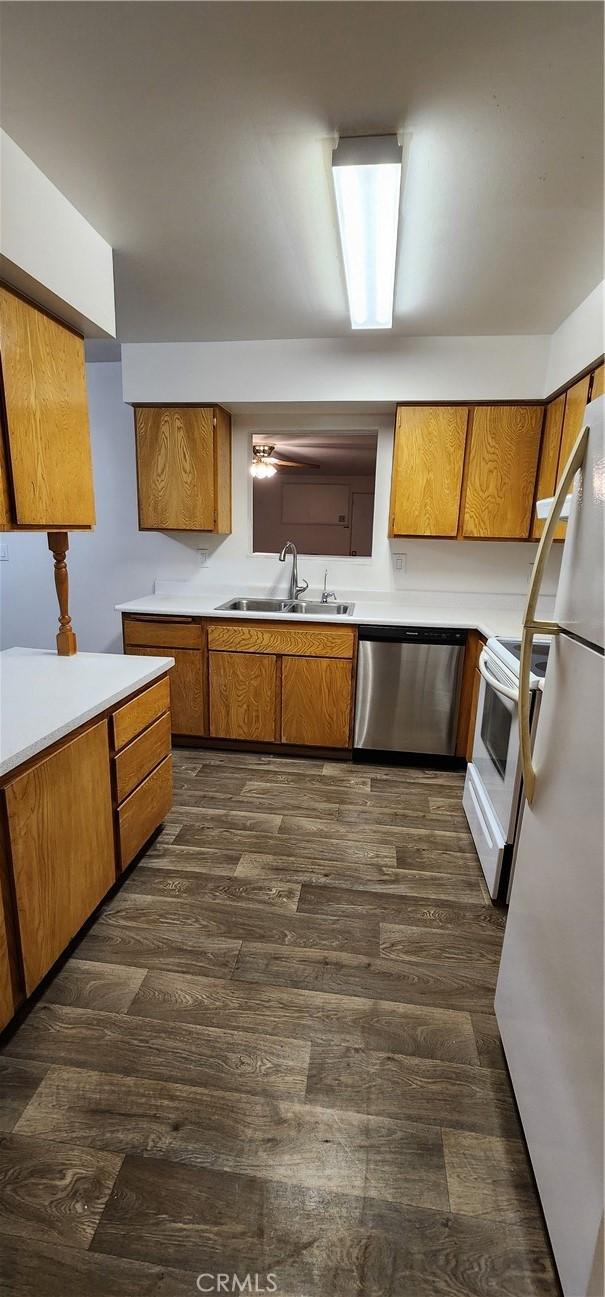 1030 N Lovekin # 27, Blythe, CA 92225 - kitchen featuring light countertops, brown cabinetry, a sink, and white appliances