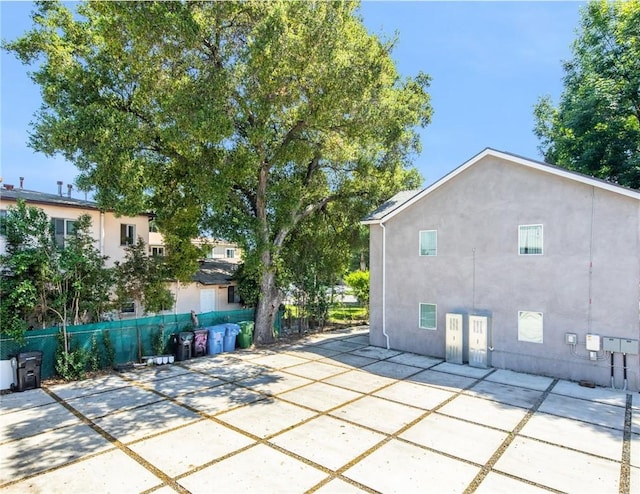 view of patio featuring fence