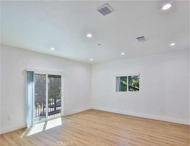 empty room featuring recessed lighting, light wood-style flooring, and visible vents