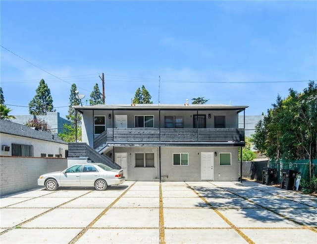 view of front of property with fence and stairs