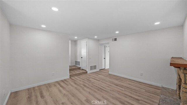 unfurnished living room with recessed lighting, visible vents, and wood finished floors