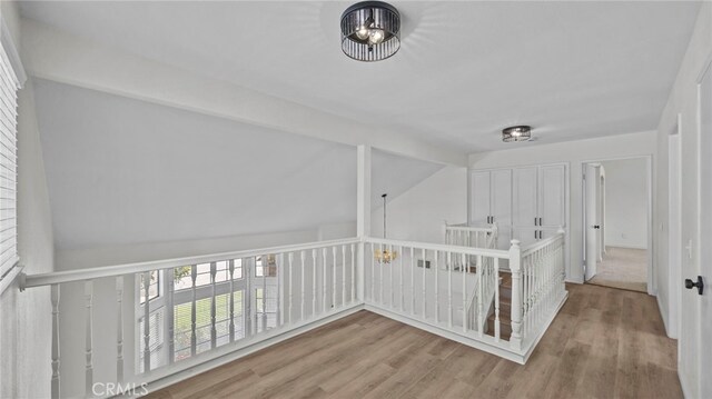 bonus room featuring wood finished floors and lofted ceiling