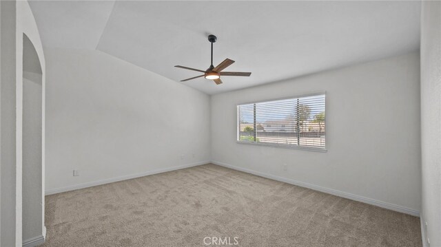 unfurnished room with baseboards, ceiling fan, carpet, and lofted ceiling