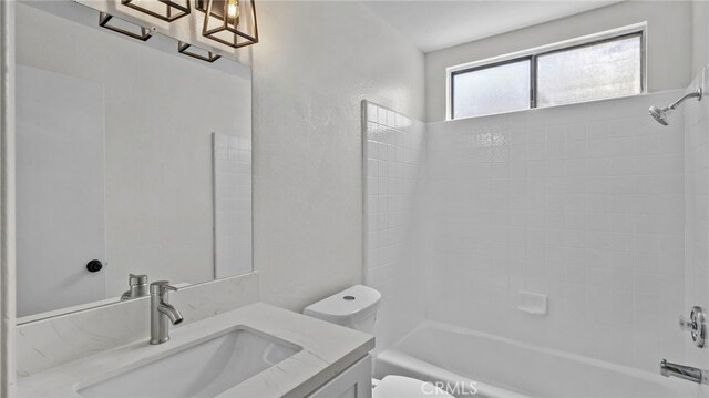 bathroom featuring vanity, shower / bathing tub combination, and toilet