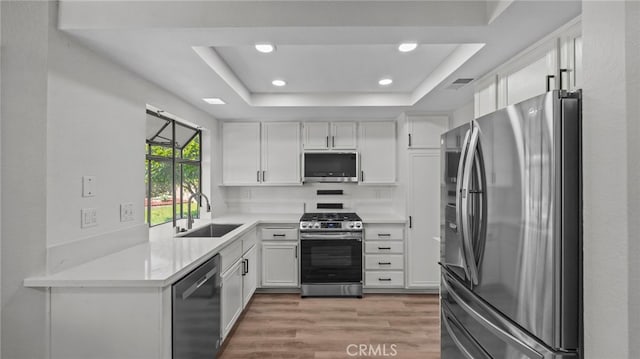 kitchen featuring a sink, appliances with stainless steel finishes, recessed lighting, and white cabinetry