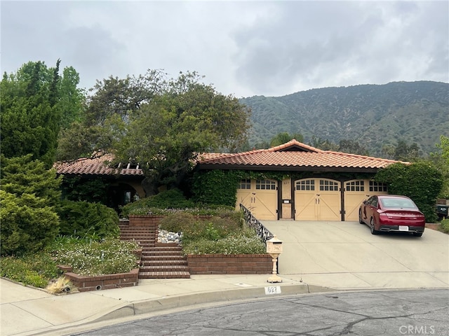 627 N Valencia St, Glendora, CA 91741 - mediterranean / spanish house with a mountain view, concrete driveway, a garage, a tile roof, and stucco siding