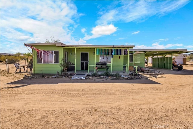 view of front of house with a carport and driveway