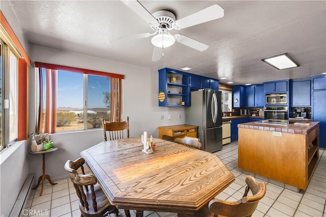 kitchen featuring blue cabinets, stainless steel appliances, open shelves, tile countertops, and light tile patterned floors