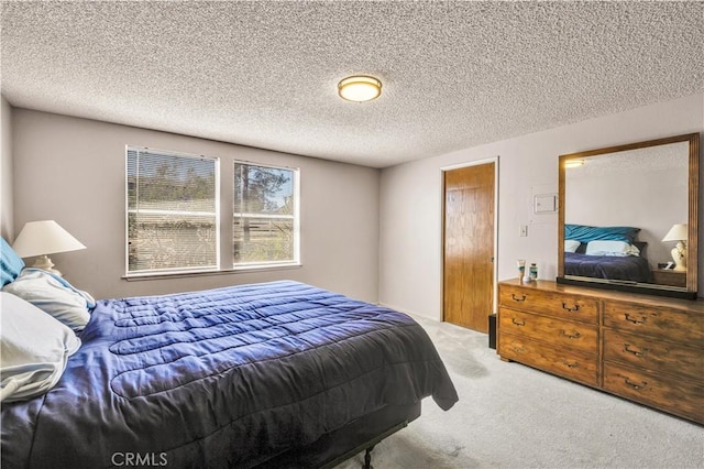 carpeted bedroom with a textured ceiling