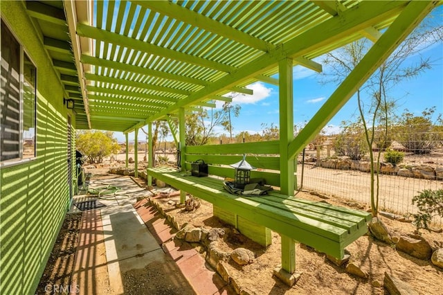 exterior space featuring fence and a pergola