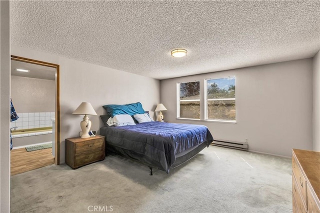 bedroom with a baseboard heating unit, carpet flooring, and a textured ceiling
