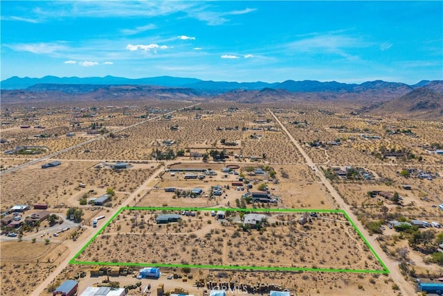 birds eye view of property featuring a mountain view and a desert view