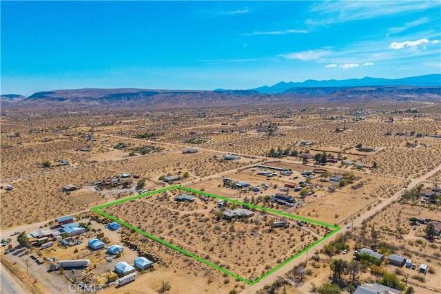 bird's eye view featuring a mountain view, a desert view, and a rural view
