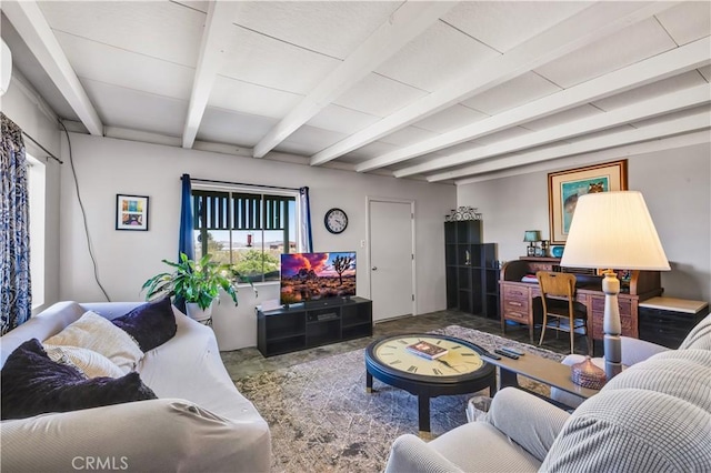 living area with beamed ceiling and concrete flooring