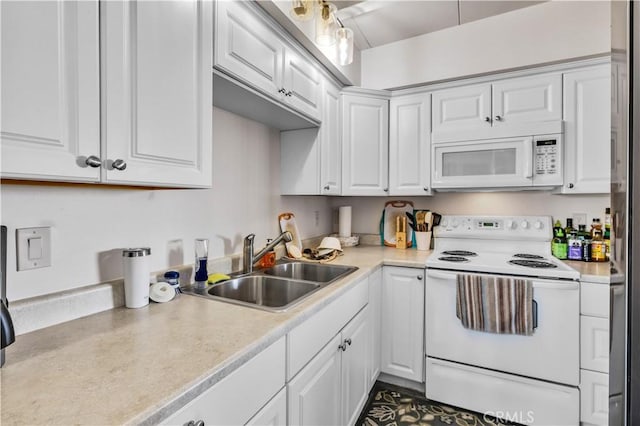 kitchen featuring light countertops, a sink, white cabinetry, and white appliances