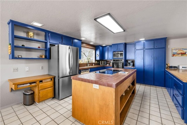 kitchen featuring blue cabinets, a center island, black appliances, open shelves, and light tile patterned floors