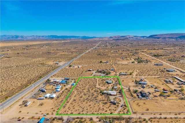bird's eye view featuring a rural view, view of desert, and a mountain view