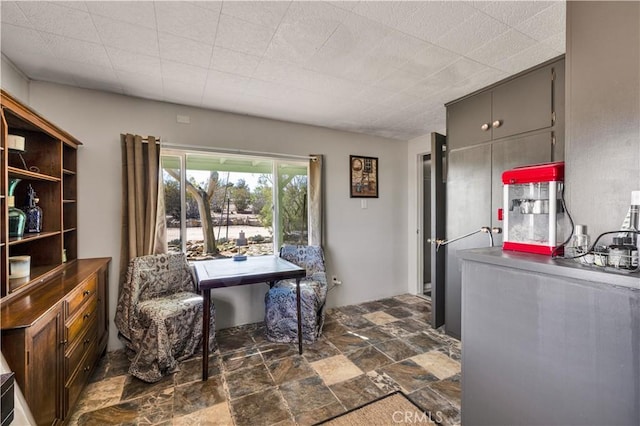 home office featuring stone finish flooring