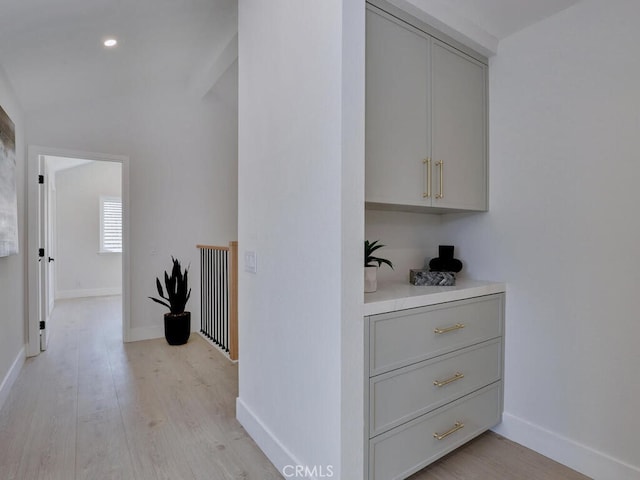 hallway with recessed lighting, light wood-type flooring, and baseboards