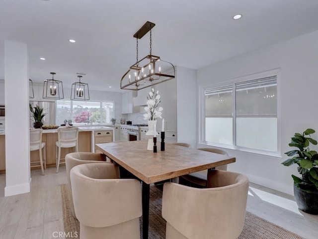 dining area featuring recessed lighting, a chandelier, light wood-style floors, and baseboards