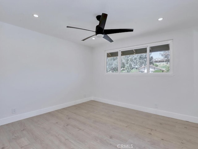 unfurnished room with recessed lighting, light wood finished floors, a ceiling fan, and baseboards