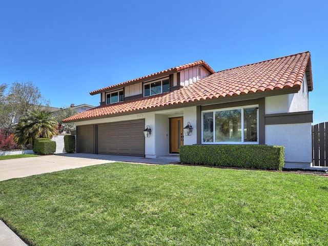 mediterranean / spanish house featuring a front lawn, a tiled roof, driveway, a garage, and stucco siding