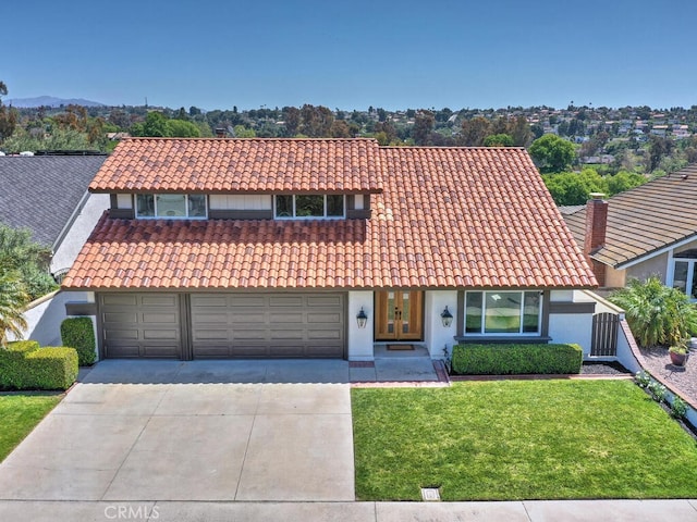 mediterranean / spanish-style home featuring concrete driveway, a front lawn, a tiled roof, french doors, and stucco siding