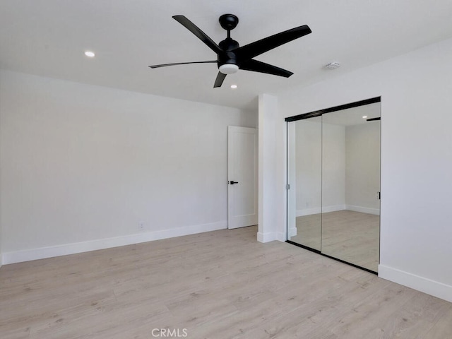 unfurnished bedroom with recessed lighting, wood finished floors, a closet, ceiling fan, and baseboards