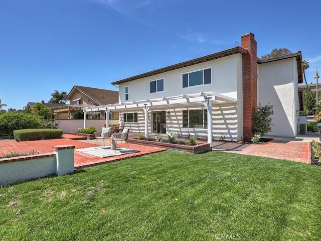 back of house featuring a pergola, a patio, a lawn, a chimney, and stucco siding