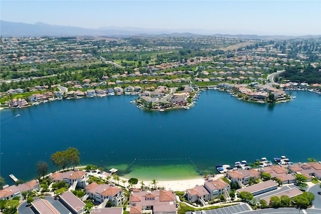 drone / aerial view with a residential view and a water and mountain view