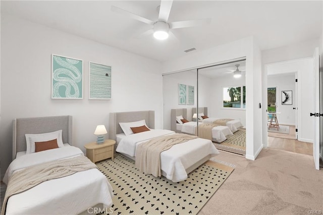bedroom featuring visible vents, ceiling fan, carpet flooring, and a closet