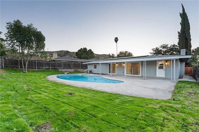 view of pool with a lawn, a patio area, a fenced in pool, and a fenced backyard