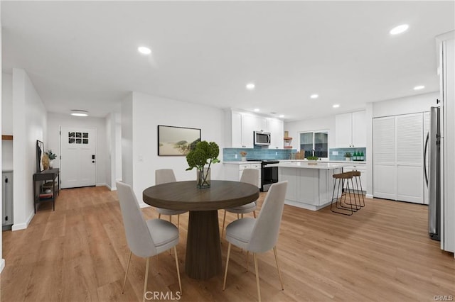 dining area featuring baseboards, recessed lighting, and light wood-style floors