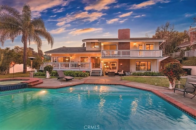 25641 Rapid Falls Rd, Laguna Hills, CA 92653 - back of house at dusk featuring a balcony, a patio area, a chimney, and a deck